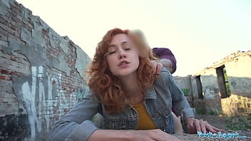 A seductive redheaded server performs oral sex and engages in doggy-style intercourse in a public setting, captured from a first-person perspective